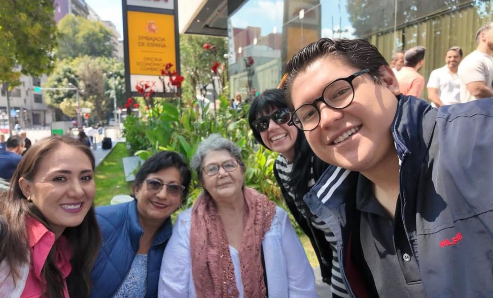 Group of clients smiling outside the Embassy of Spain in Mexico City